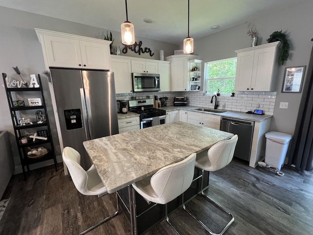 2650 Eagle Rdg, Muskegon, MI 49444 - kitchen featuring stainless steel appliances, dark wood finished floors, backsplash, and white cabinetry