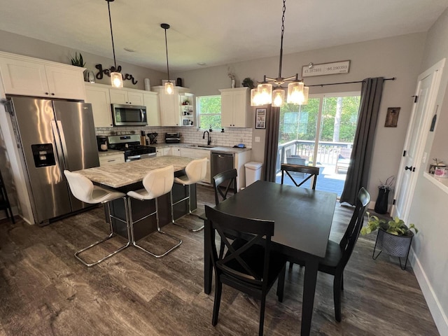 2650 Eagle Rdg, Muskegon, MI 49444 - dining space with dark wood-style floors and a chandelier