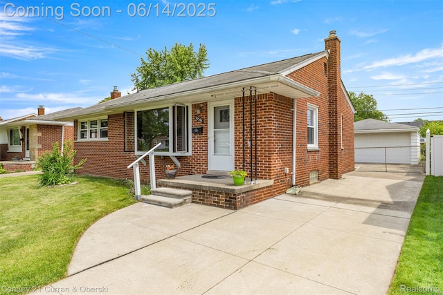 30345 Rush St, Garden City, MI 48135 - view of front of home with a chimney, brick siding, and a detached garage