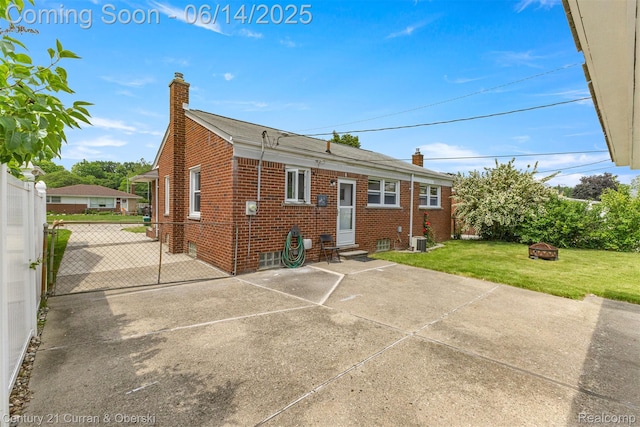 30345 Rush St, Garden City, MI 48135 - rear view of property featuring a chimney, brick siding, a patio area, and entry steps