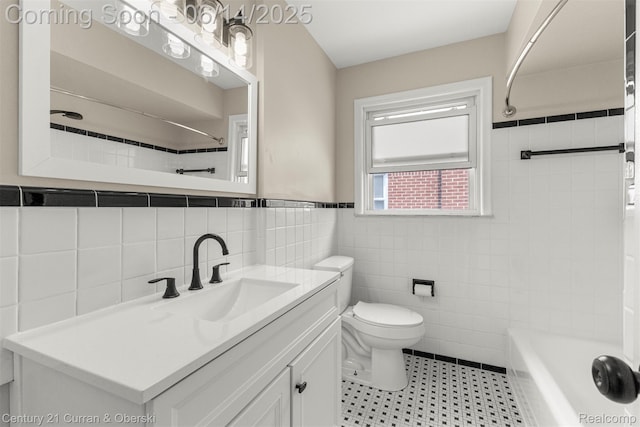 30345 Rush St, Garden City, MI 48135 - bathroom featuring tile walls, vanity, wainscoting, tile patterned floors, and tub / shower combination