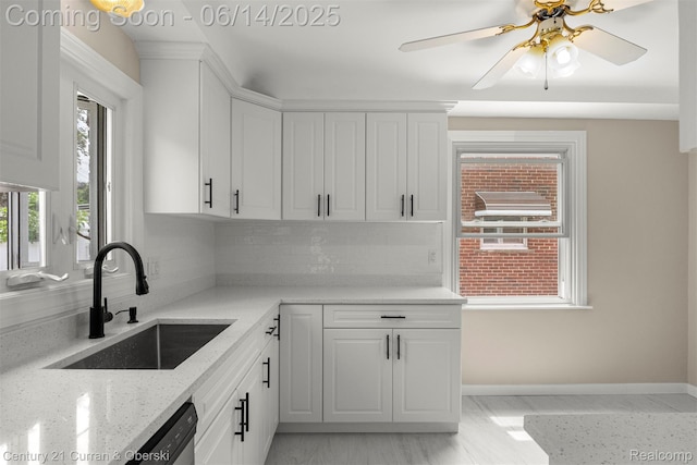 30345 Rush St, Garden City, MI 48135 - kitchen with decorative backsplash, white cabinets, light stone counters, ceiling fan, and stainless steel dishwasher