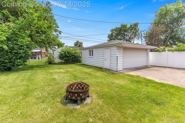 30345 Rush St, Garden City, MI 48135 - view of yard featuring a fire pit, a detached garage, and an outdoor structure