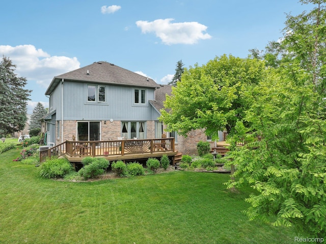2138 Kennedy Dr, Rochester Hills, MI 48309 - rear view of house with brick siding, a deck, a lawn, and roof with shingles