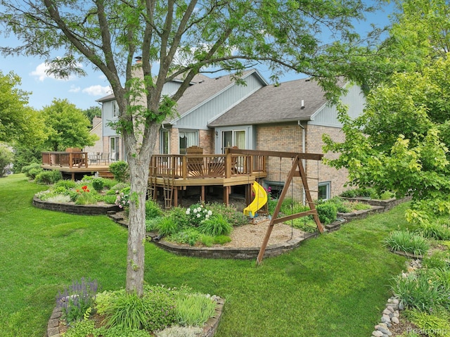 2138 Kennedy Dr, Rochester Hills, MI 48309 - rear view of house with brick siding, a deck, a yard, and roof with shingles