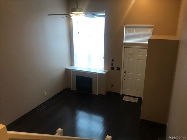13635 Osborn Ave Unit 126, Dearborn, MI 48126 - entrance foyer with healthy amount of natural light, ceiling fan, dark wood-style flooring, and a fireplace