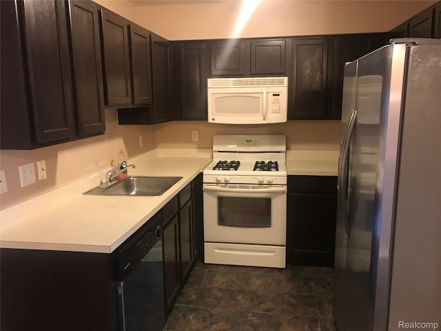 13635 Osborn Ave Unit 126, Dearborn, MI 48126 - kitchen with white appliances, light countertops, dark brown cabinetry, and dark stone finish flooring