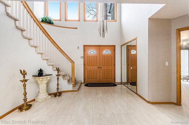 5322 Pond Bluff Dr, West Bloomfield, MI 48323 - entryway with healthy amount of natural light, stairway, and a towering ceiling
