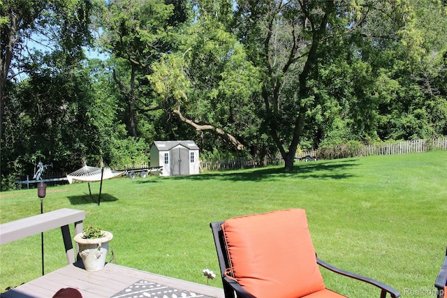 14361 Blue Heron Dr, Fenton, MI 48430 - view of yard featuring a shed, view of scattered trees, and a wooden deck