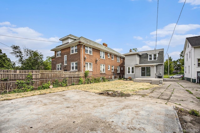 2934 Virginia Park St, Livonia, MI 48206 - back of property with a patio and a shingled roof