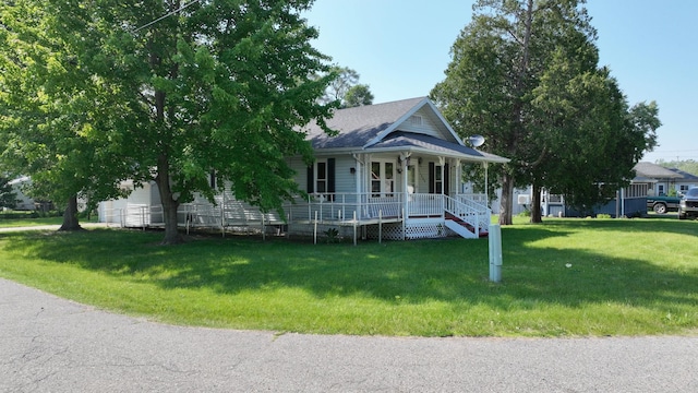 11469 Haven St, Clio, MI 48420 - view of front of home featuring covered porch, a front lawn, and a garage