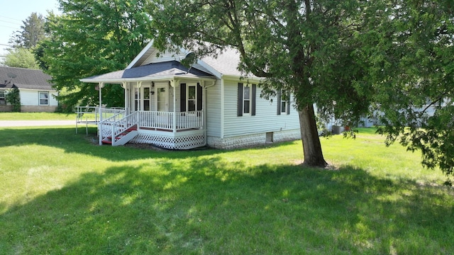 11469 Haven St, Clio, MI 48420 - view of front facade with covered porch, a front yard, and stairway