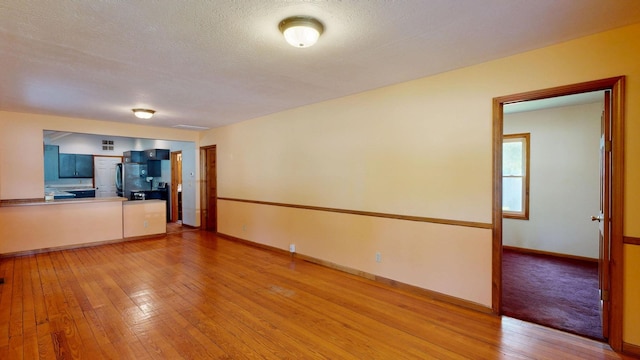 11469 Haven St, Clio, MI 48420 - unfurnished living room featuring light wood-type flooring and baseboards