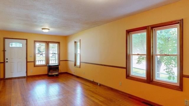 11469 Haven St, Clio, MI 48420 - entrance foyer with hardwood / wood-style floors and a textured ceiling