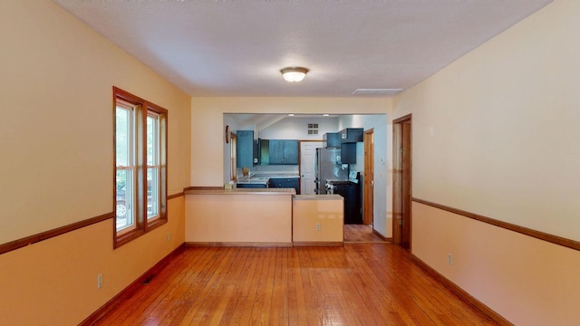11469 Haven St, Clio, MI 48420 - unfurnished living room featuring light wood-type flooring and baseboards