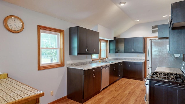11469 Haven St, Clio, MI 48420 - kitchen featuring stainless steel appliances, light wood-style floors, vaulted ceiling, dark brown cabinetry, and recessed lighting