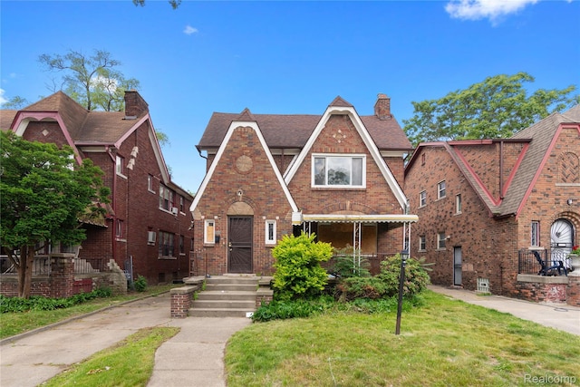 17327 Indiana St, Detroit, MI 48221 - english style home featuring brick siding, a chimney, and a front yard