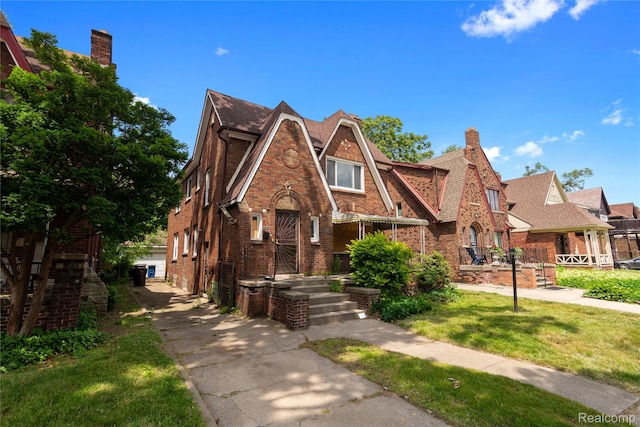 17327 Indiana St, Detroit, MI 48221 - tudor house with brick siding and a front lawn