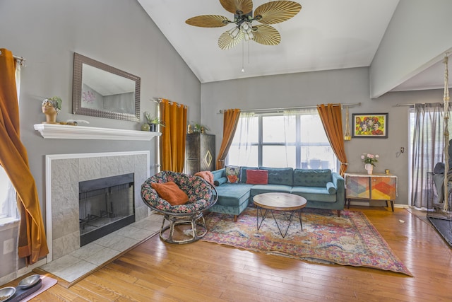 4315 Knollcrest Dr, Ann Arbor, MI 48108 - living room with ceiling fan, hardwood / wood-style floors, plenty of natural light, a tiled fireplace, and high vaulted ceiling