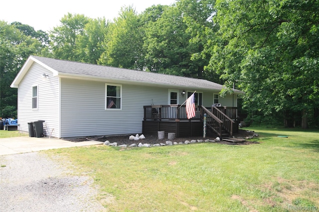 12850 E Rd, Burt, MI 48417 - ranch-style house featuring a deck and a front lawn