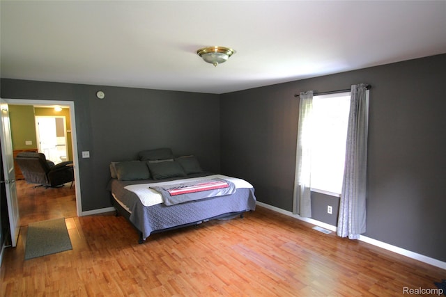 12850 E Rd, Burt, MI 48417 - bedroom with light wood-type flooring and baseboards