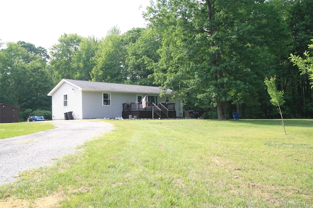 12850 E Rd, Burt, MI 48417 - view of front facade with a wooden deck, gravel driveway, a front lawn, and stairway
