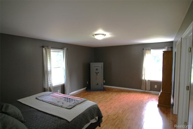 12850 E Rd, Burt, MI 48417 - bedroom with multiple windows and light wood-style floors