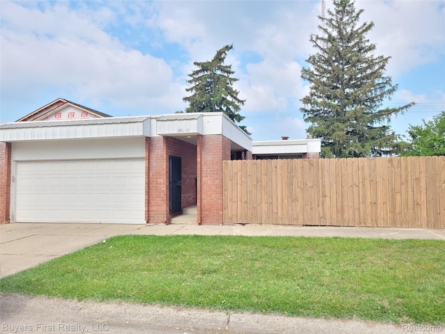 26001 Harding Sq, Oak Park, MI 48237 - view of front of home with brick siding, an attached garage, and concrete driveway