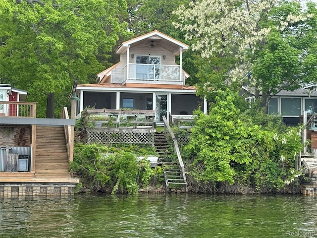 13358 Wendell St, Fenton, MI 48430 - view of front facade with a balcony, stairway, and a water view