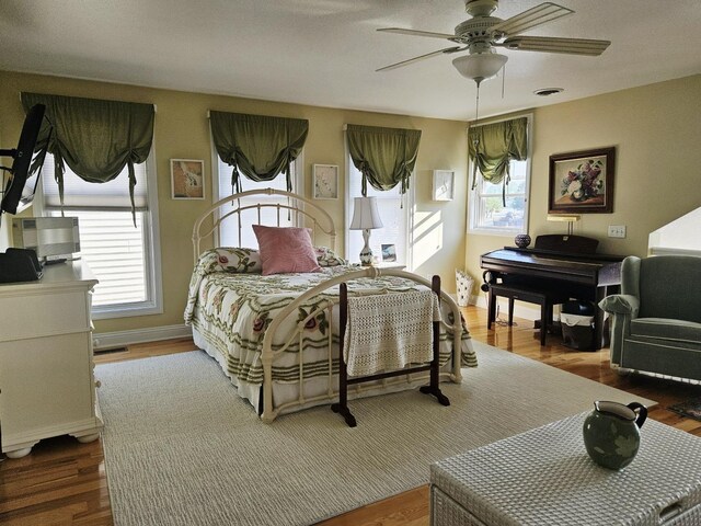 1005 W Lake St, Tawas City, MI 48763 - bedroom featuring wood finished floors and ceiling fan