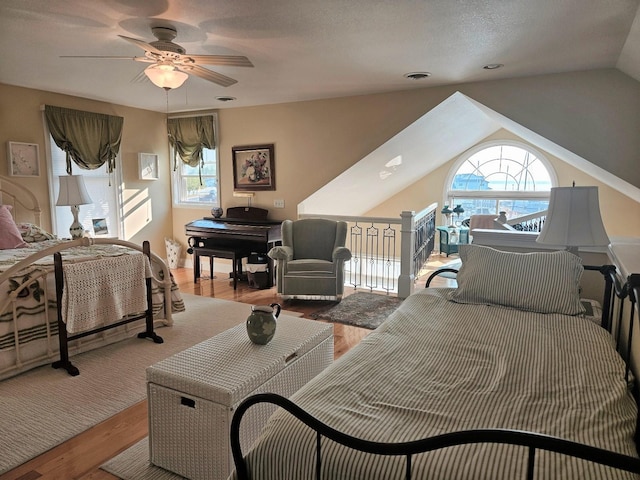 1005 W Lake St, Tawas City, MI 48763 - bedroom featuring wood finished floors, lofted ceiling, and ceiling fan