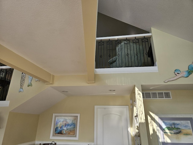 1005 W Lake St, Tawas City, MI 48763 - staircase featuring lofted ceiling and a textured ceiling
