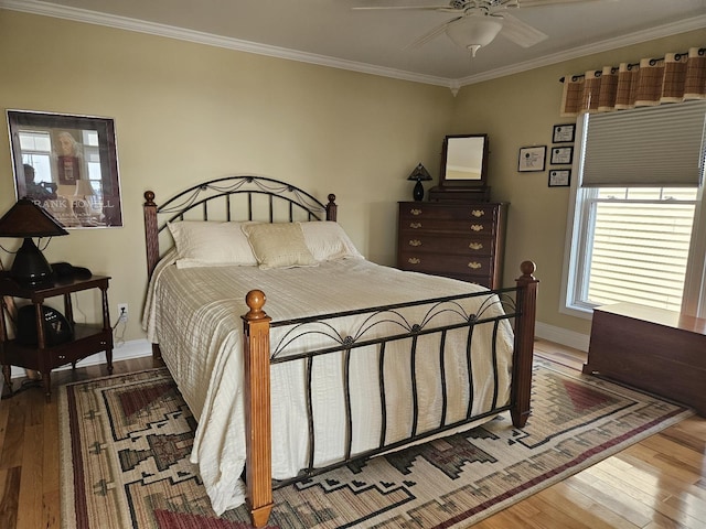 1005 W Lake St, Tawas City, MI 48763 - bedroom featuring wood finished floors, ornamental molding, and a ceiling fan