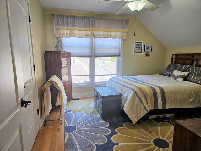 1005 W Lake St, Tawas City, MI 48763 - bedroom featuring lofted ceiling, light wood-type flooring, and ceiling fan