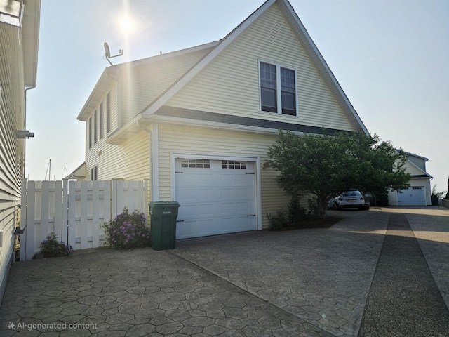 1005 W Lake St, Tawas City, MI 48763 - view of side of property featuring an attached garage and driveway