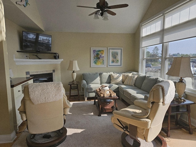 1005 W Lake St, Tawas City, MI 48763 - carpeted living room featuring a ceiling fan, lofted ceiling, and a glass covered fireplace