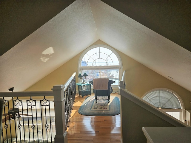 1005 W Lake St, Tawas City, MI 48763 - staircase featuring wood finished floors, a textured ceiling, and vaulted ceiling