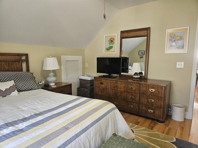 1005 W Lake St, Tawas City, MI 48763 - bedroom with lofted ceiling and wood finished floors