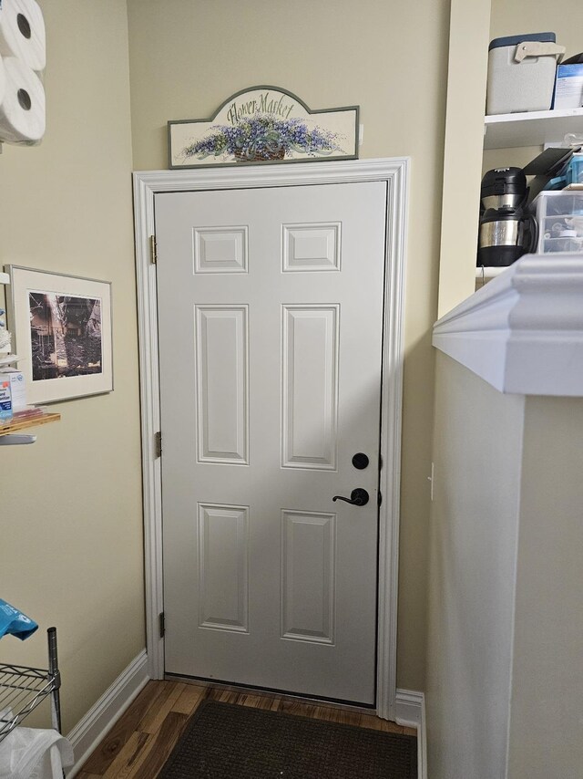 1005 W Lake St, Tawas City, MI 48763 - entryway with dark wood-type flooring and baseboards