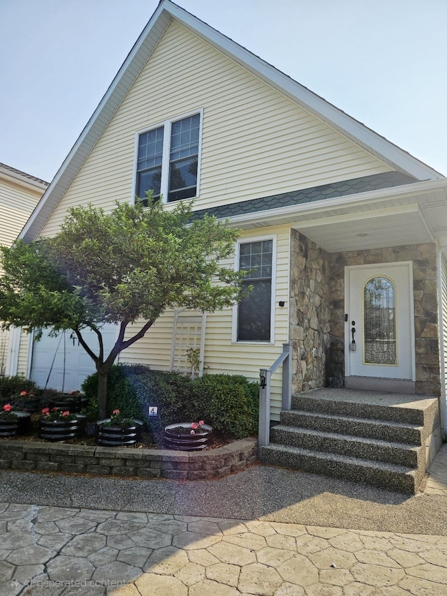 1005 W Lake St, Tawas City, MI 48763 - view of front of home featuring stone siding