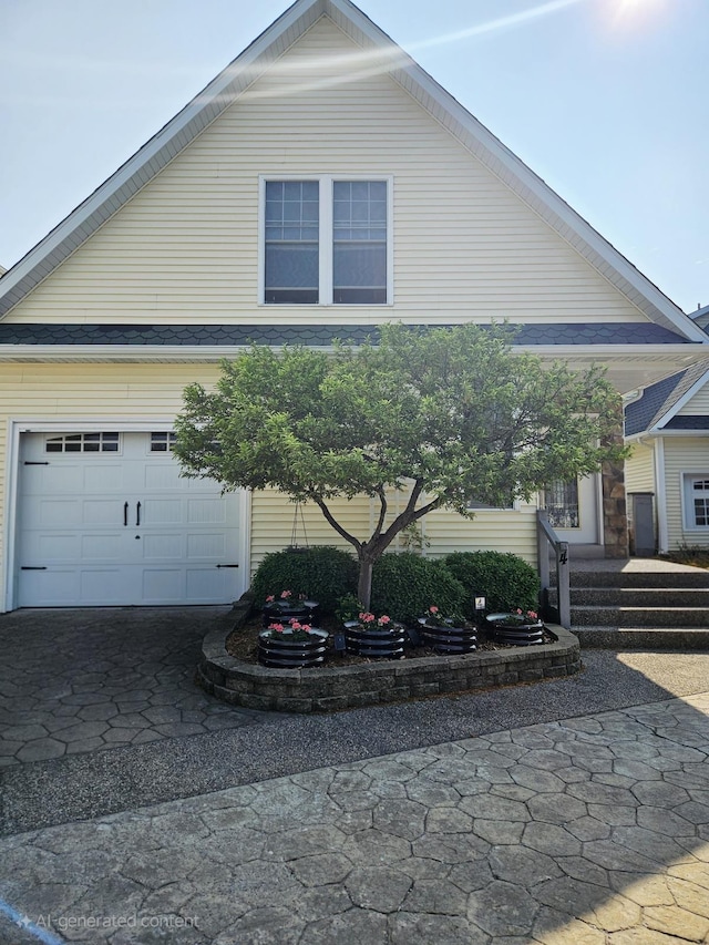 1005 W Lake St, Tawas City, MI 48763 - view of property exterior featuring a garage and driveway