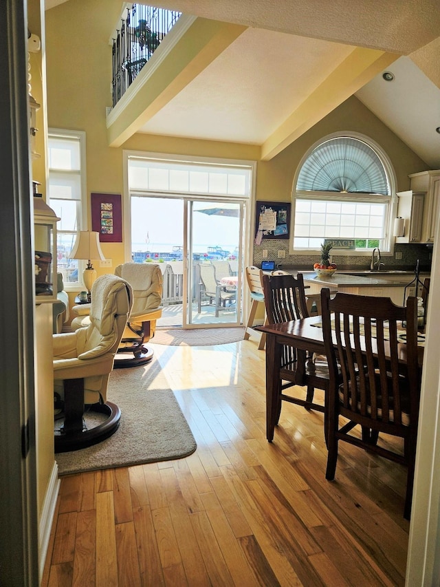 1005 W Lake St, Tawas City, MI 48763 - dining space featuring light wood-style floors, lofted ceiling, and recessed lighting