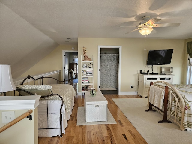 1005 W Lake St, Tawas City, MI 48763 - bedroom featuring wood finished floors, vaulted ceiling, and a ceiling fan