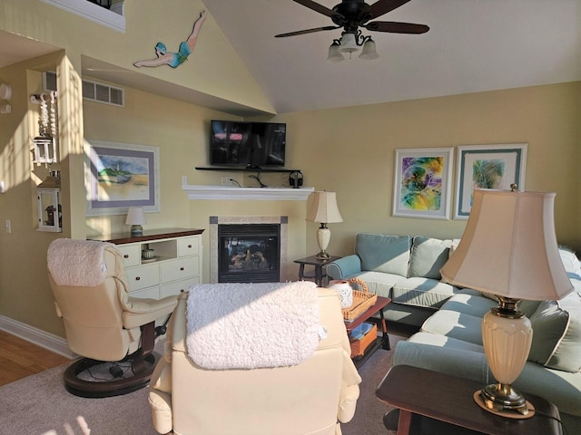 1005 W Lake St, Tawas City, MI 48763 - living area with a ceiling fan, a glass covered fireplace, vaulted ceiling, and wood finished floors