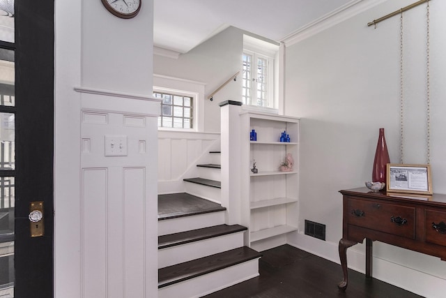643 Giddings Ave SE, Grand Rapids, MI 49506 - staircase featuring crown molding, wood finished floors, and wainscoting