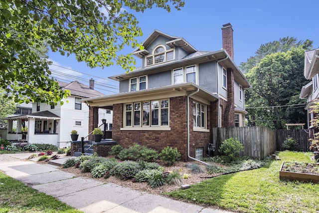 643 Giddings Ave SE, Grand Rapids, MI 49506 - american foursquare style home featuring a chimney, brick siding, and stucco siding