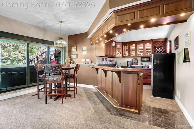 2985 Dana Pointe Dr, Pinckney, MI 48169 - kitchen featuring freestanding refrigerator, black microwave, light colored carpet, glass insert cabinets, and a peninsula