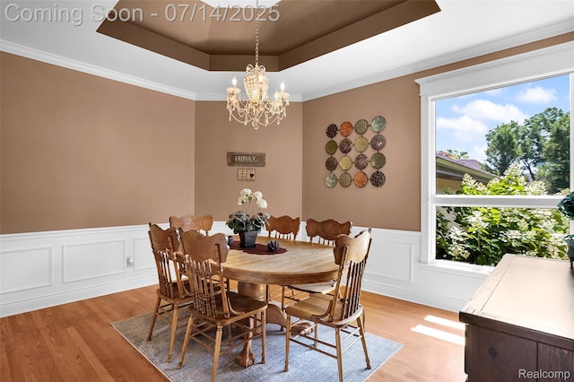 2985 Dana Pointe Dr, Pinckney, MI 48169 - dining area featuring light wood finished floors, healthy amount of natural light, a raised ceiling, a chandelier, and a wainscoted wall