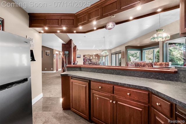 2985 Dana Pointe Dr, Pinckney, MI 48169 - kitchen with freestanding refrigerator, dark countertops, pendant lighting, open floor plan, and recessed lighting