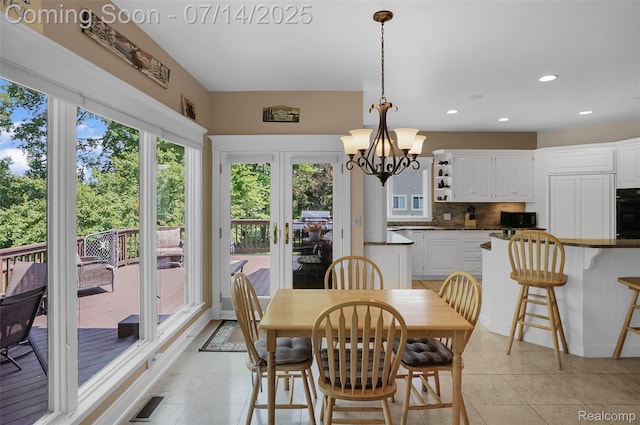 2985 Dana Pointe Dr, Pinckney, MI 48169 - dining area featuring light tile patterned floors, recessed lighting, and a chandelier